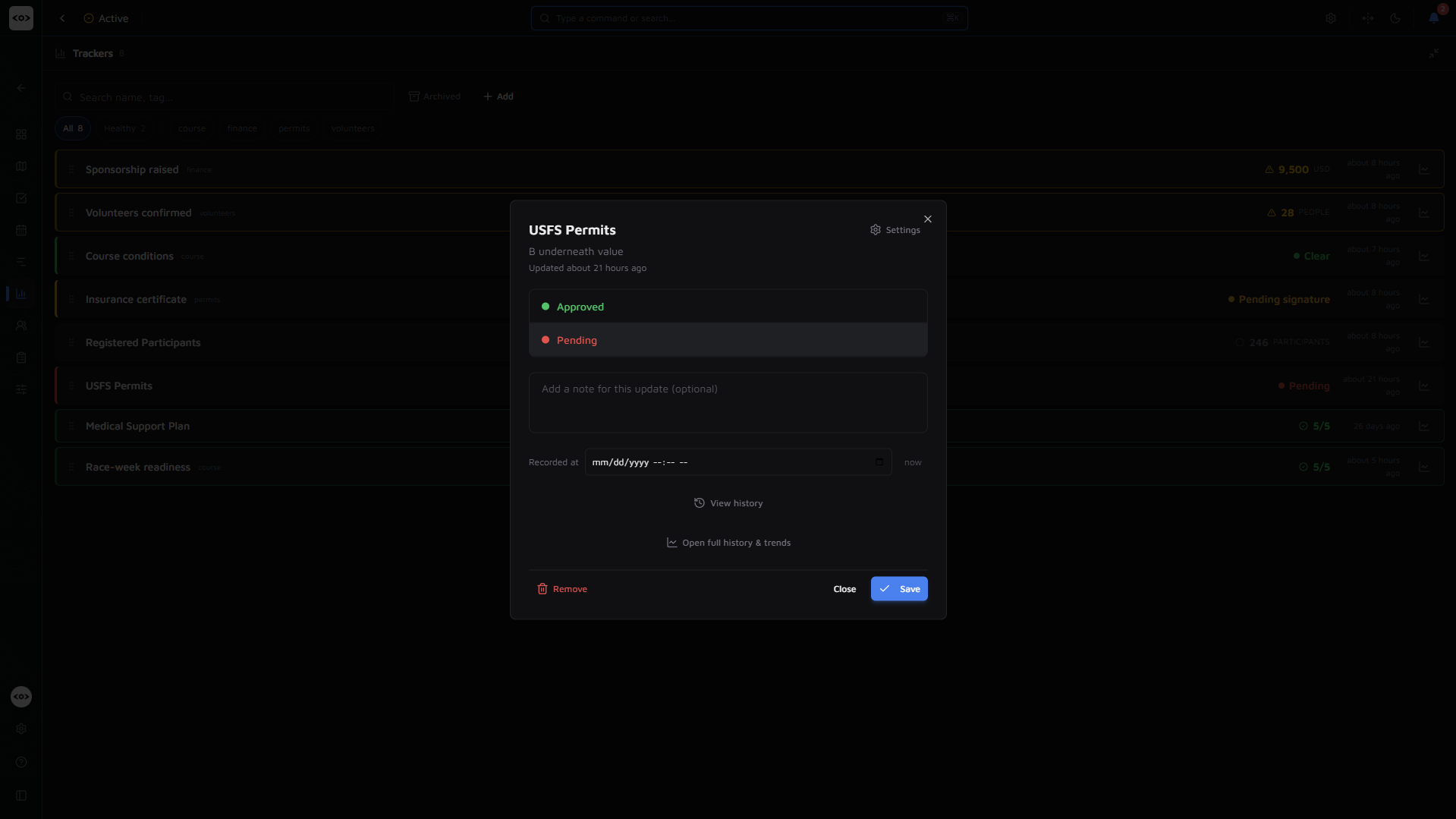 OpsCommon tracker update dialog — switching a permit tracker between approved and pending with an optional note